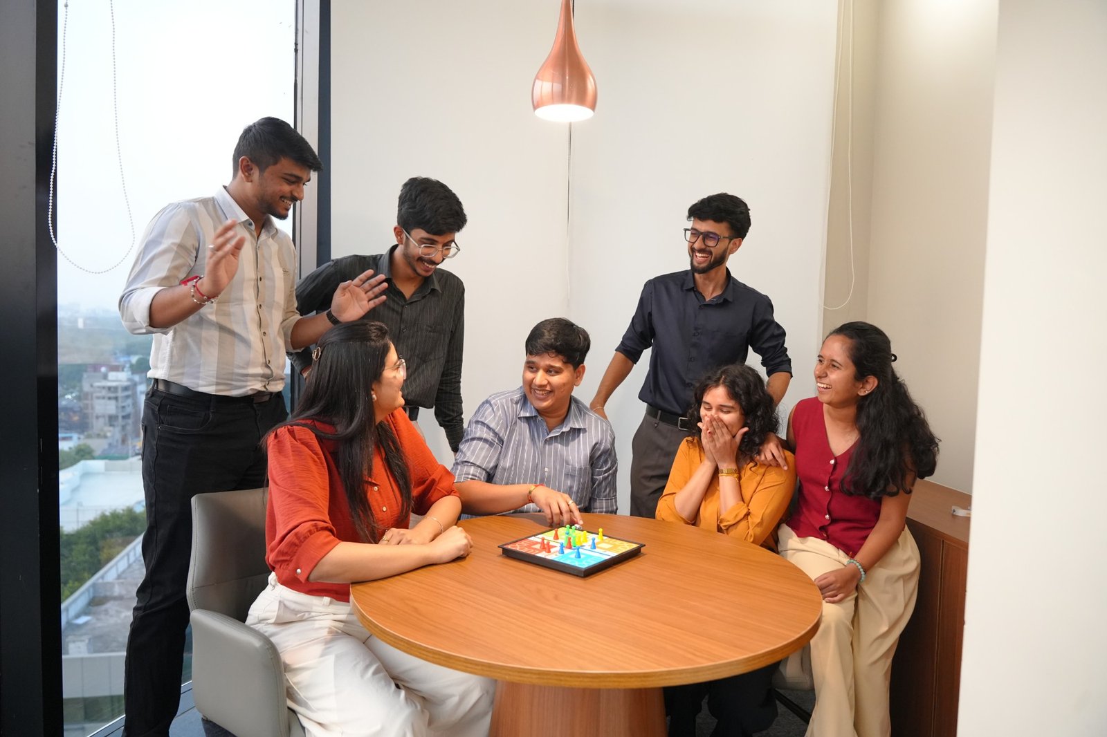 Colleagues laughing over a board game