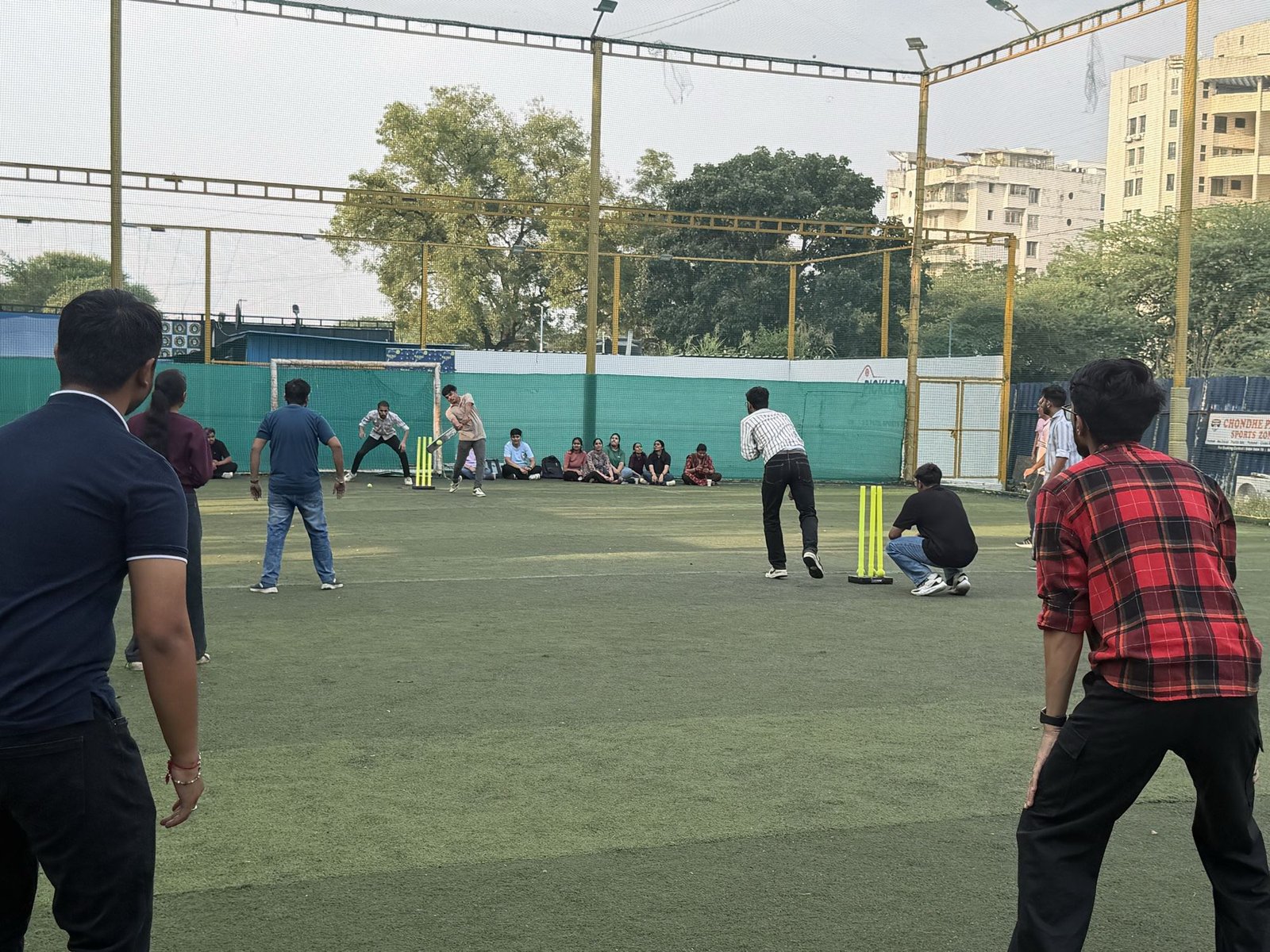 The team playing a game of cricket