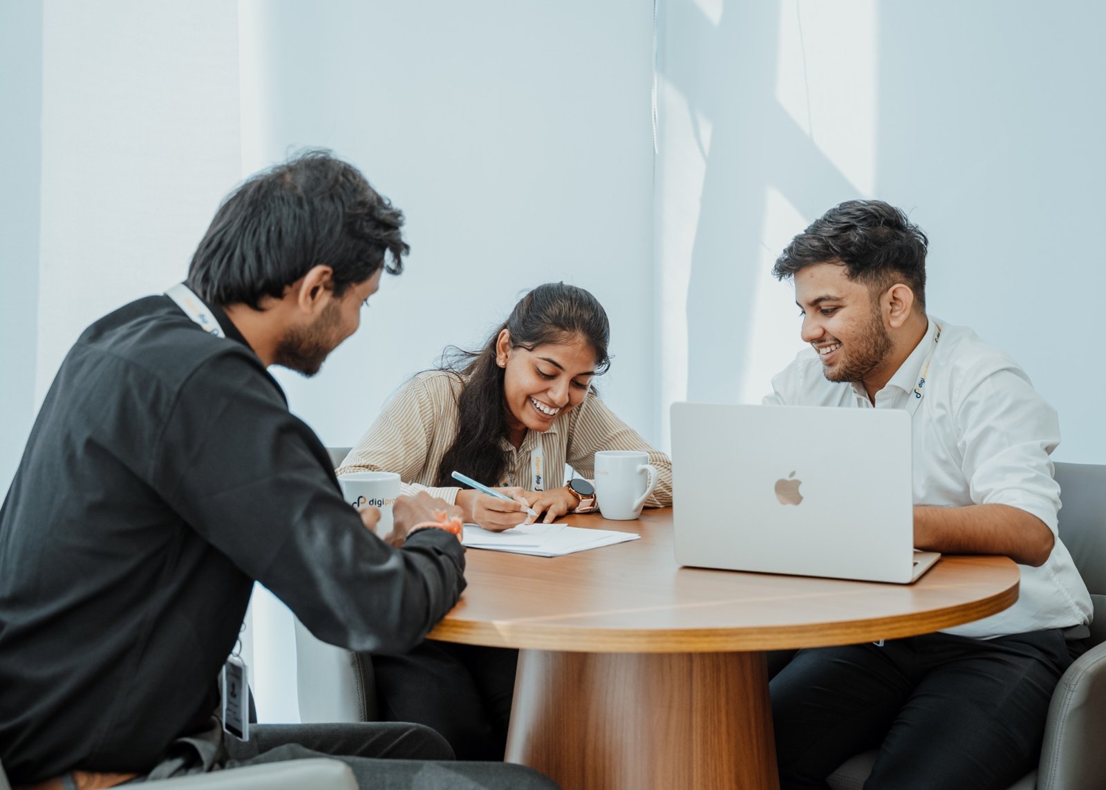 Three colleagues working together at a table